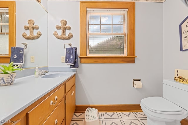 bathroom with tile patterned floors, vanity, and toilet