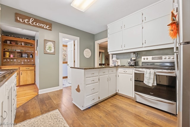 kitchen featuring kitchen peninsula, appliances with stainless steel finishes, light wood-type flooring, and white cabinetry