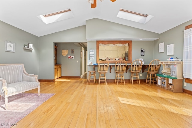 interior space featuring light hardwood / wood-style floors, vaulted ceiling, and ceiling fan