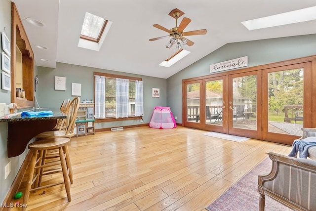 game room featuring lofted ceiling, ceiling fan, french doors, and light hardwood / wood-style flooring