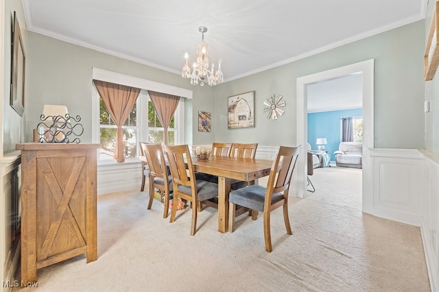 carpeted dining space featuring an inviting chandelier and crown molding