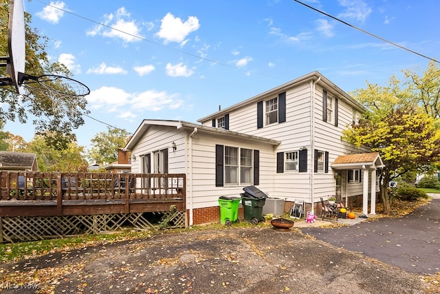 back of house featuring a deck