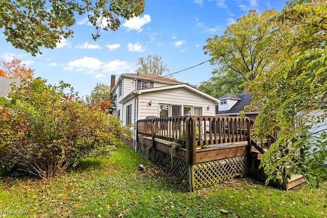 rear view of property featuring a deck