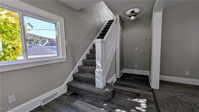 staircase featuring hardwood / wood-style flooring