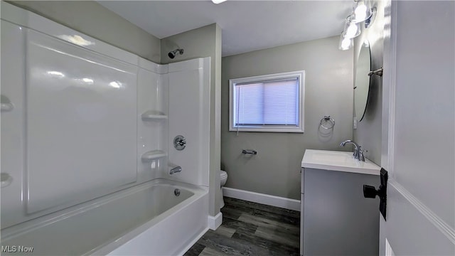 full bathroom featuring shower / bathing tub combination, vanity, hardwood / wood-style floors, and toilet