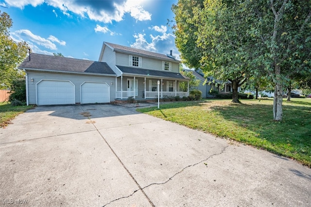 view of front facade with a garage, a front lawn, and covered porch