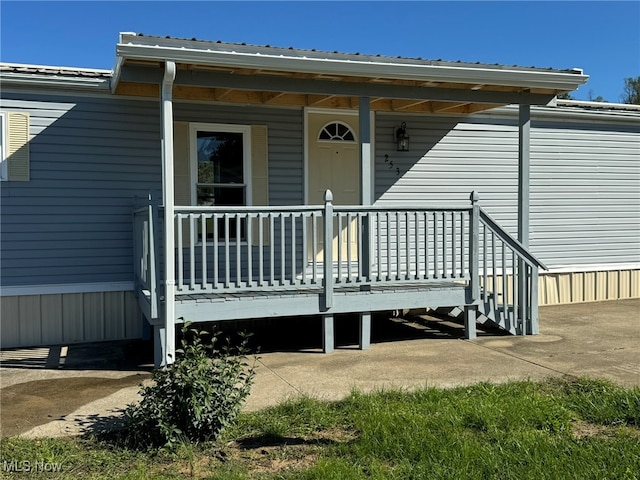 doorway to property featuring covered porch