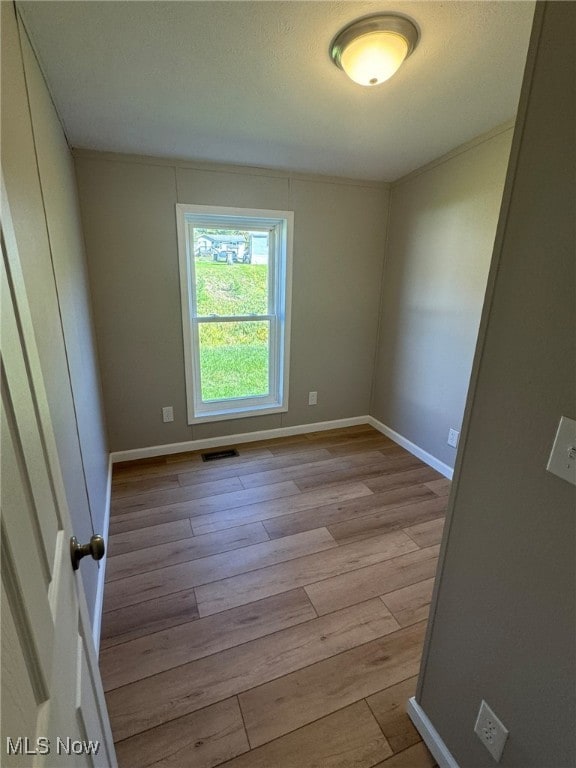 spare room with light hardwood / wood-style floors