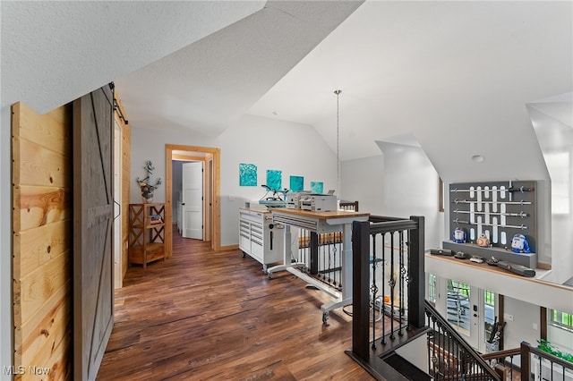 hallway featuring vaulted ceiling and dark hardwood / wood-style flooring