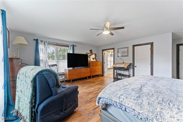 bedroom with ceiling fan, connected bathroom, and light hardwood / wood-style floors