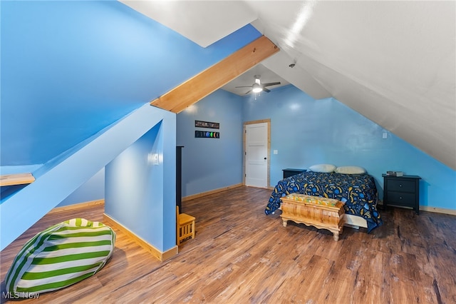 bedroom with hardwood / wood-style floors, vaulted ceiling, and ceiling fan