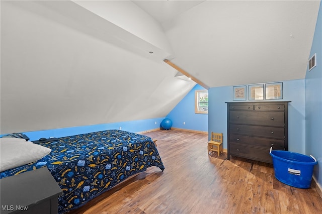 bedroom featuring lofted ceiling and wood-type flooring