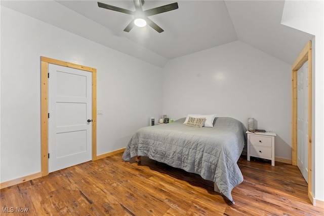 bedroom with vaulted ceiling, hardwood / wood-style flooring, and ceiling fan