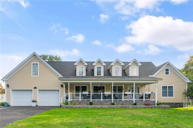 cape cod house with a front yard, a garage, and covered porch