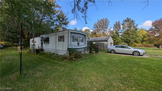 view of side of property with a lawn