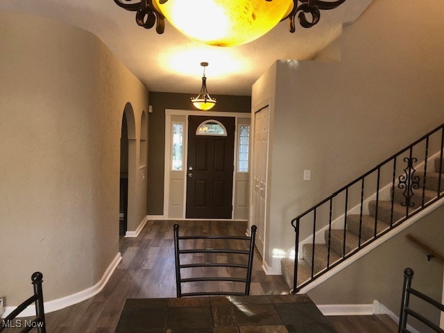 entryway with dark hardwood / wood-style flooring