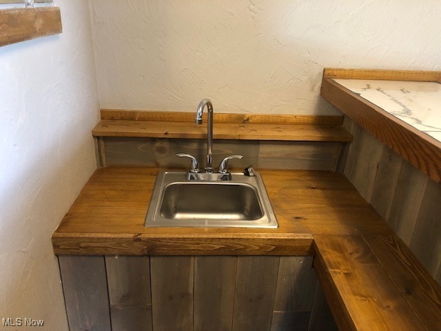 interior space with butcher block countertops and sink