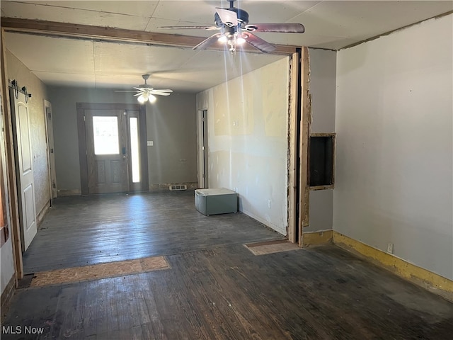 empty room featuring dark hardwood / wood-style flooring and ceiling fan