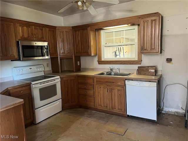 kitchen featuring ceiling fan, white appliances, and sink