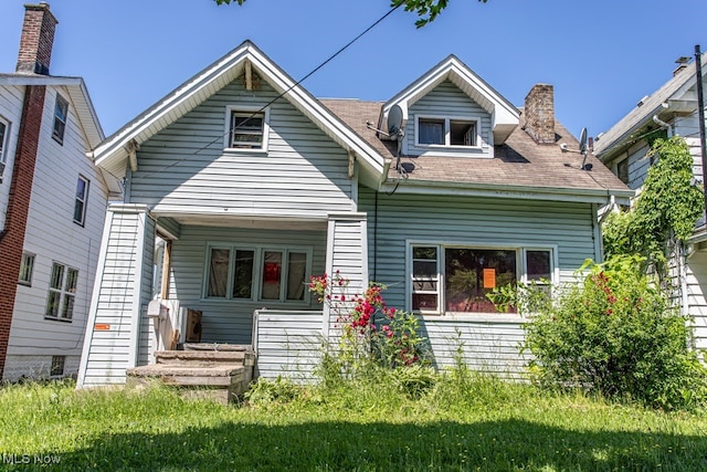 rear view of house with a lawn