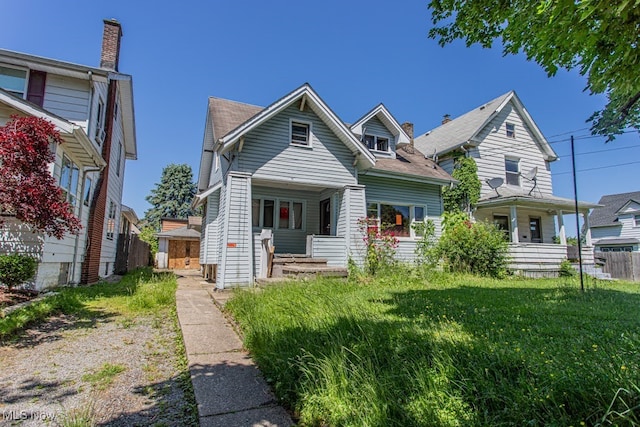 view of front of home featuring a front yard and covered porch