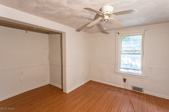 unfurnished room with ceiling fan and light hardwood / wood-style flooring