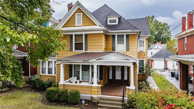 view of front of property with covered porch and a garage