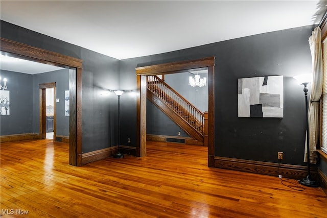 interior space featuring a chandelier and wood-type flooring