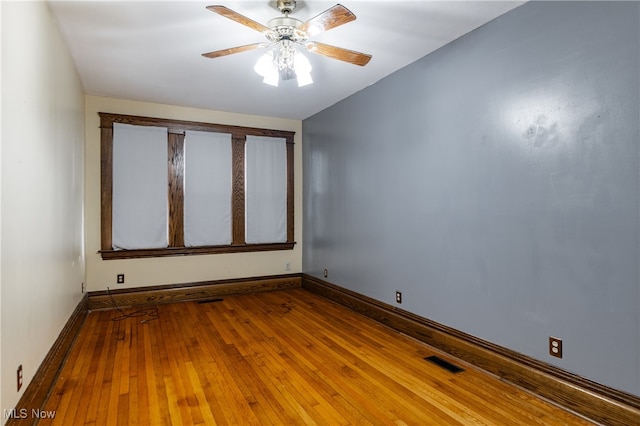 spare room with wood-type flooring and ceiling fan