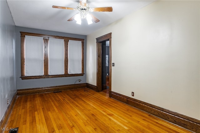 spare room featuring hardwood / wood-style floors and ceiling fan