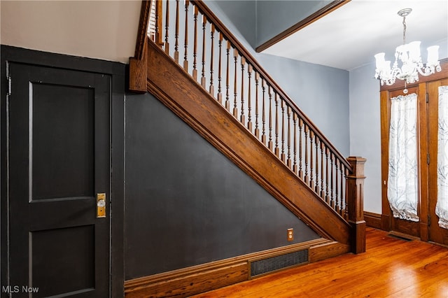 foyer featuring hardwood / wood-style floors and a notable chandelier