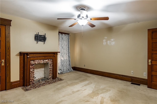 unfurnished living room featuring light carpet and ceiling fan