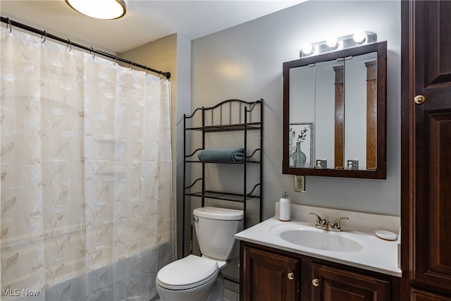 full bathroom with vanity, shower / tub combo, and toilet