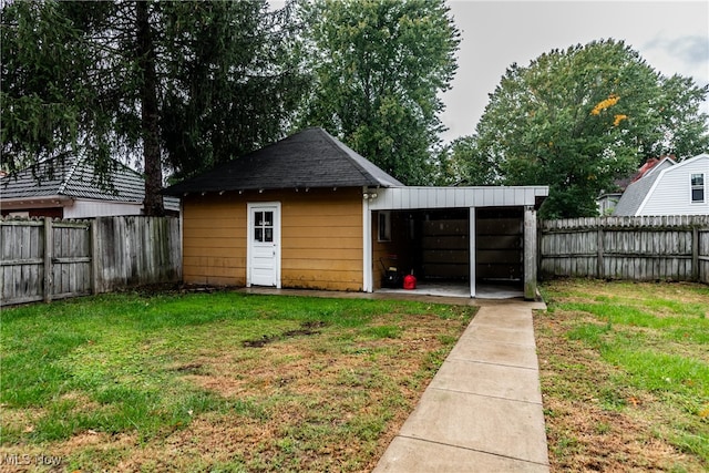 view of outbuilding featuring a yard