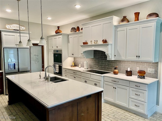 kitchen with pendant lighting, black appliances, sink, and white cabinetry