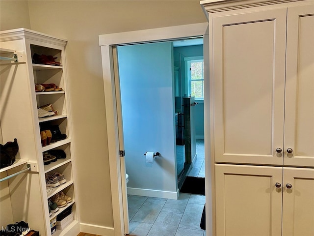 bathroom featuring tile patterned floors and toilet