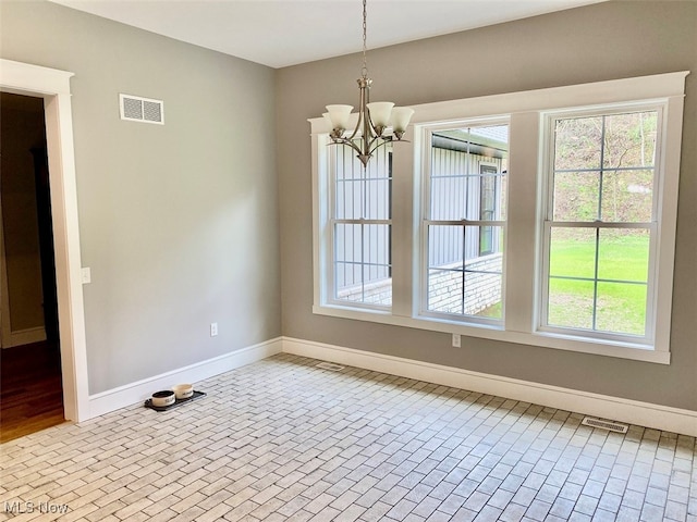 unfurnished dining area featuring an inviting chandelier