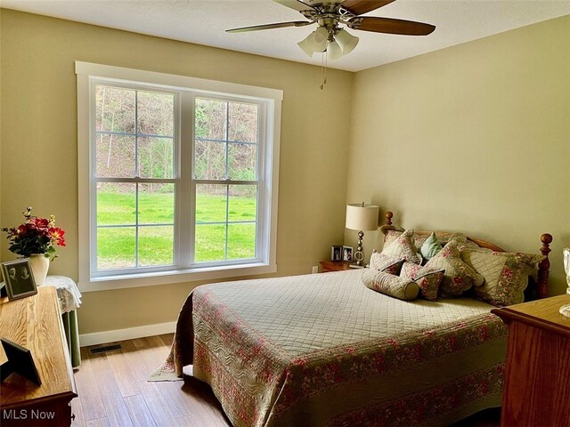 bedroom with ceiling fan and light hardwood / wood-style floors