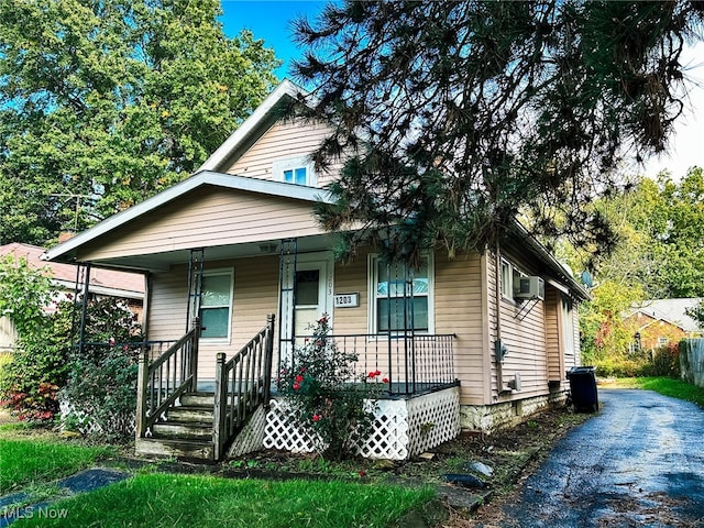 bungalow featuring cooling unit and covered porch