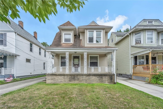 view of front of home featuring a front yard and a porch