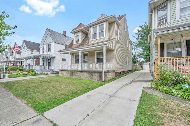 view of front of home featuring a front yard and a porch