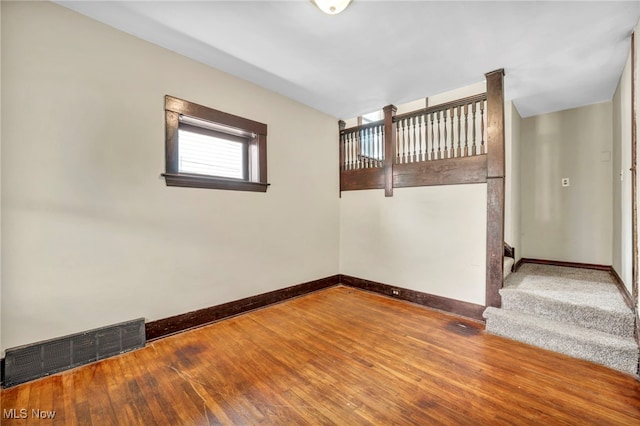 unfurnished room with hardwood / wood-style flooring