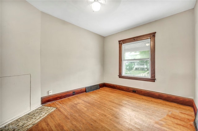 empty room featuring ceiling fan and hardwood / wood-style floors