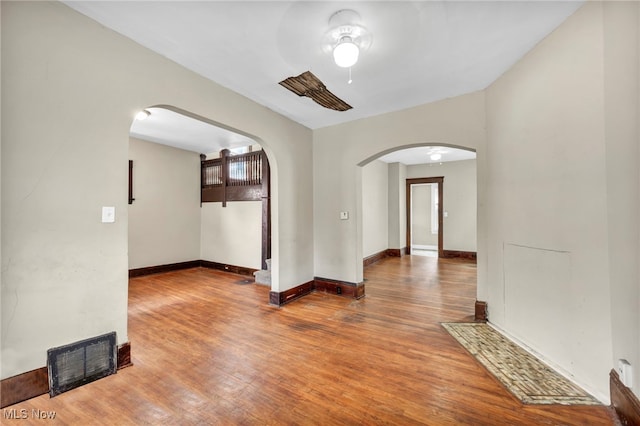 unfurnished room with ceiling fan and hardwood / wood-style floors