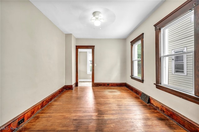 unfurnished room with ceiling fan and wood-type flooring