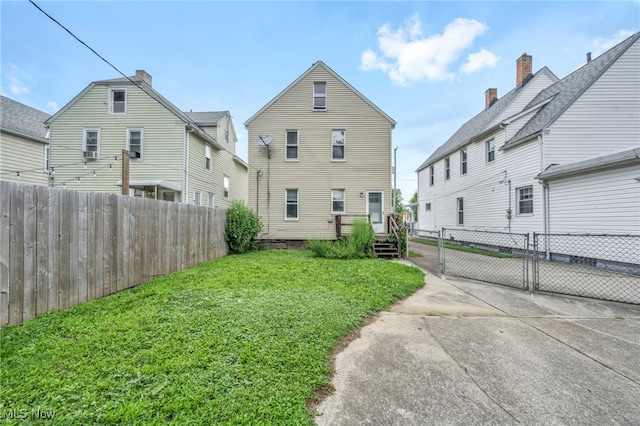 back of house with a yard