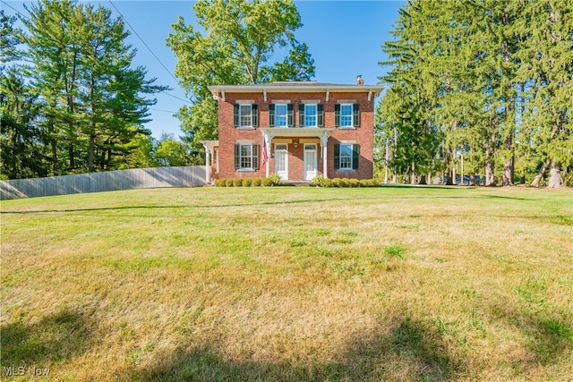 colonial home with a front lawn