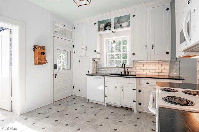 kitchen featuring tasteful backsplash, white cabinets, white appliances, sink, and pendant lighting