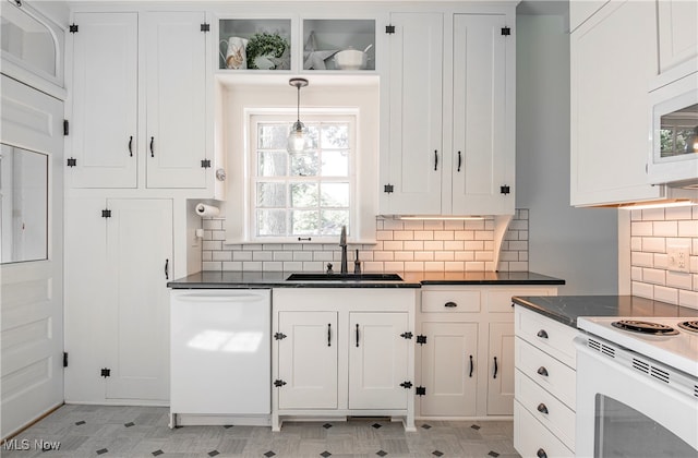 kitchen featuring white cabinetry, sink, white appliances, and a healthy amount of sunlight