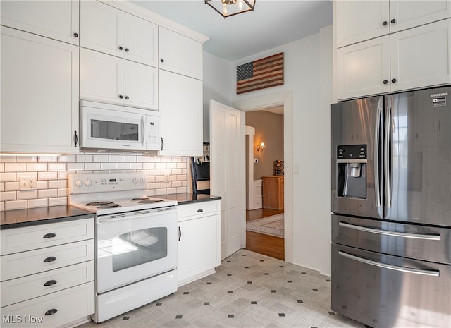 kitchen featuring white cabinets, tasteful backsplash, and white appliances